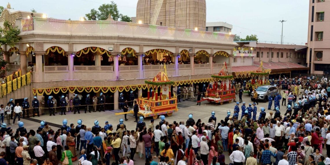Devotees gathered outside Lord Jagannath temple on the eve of the annual Ratha Yatra in Ahmedabad on June 19, 2023. (Photo by Sam PANTHAKY / AFP)